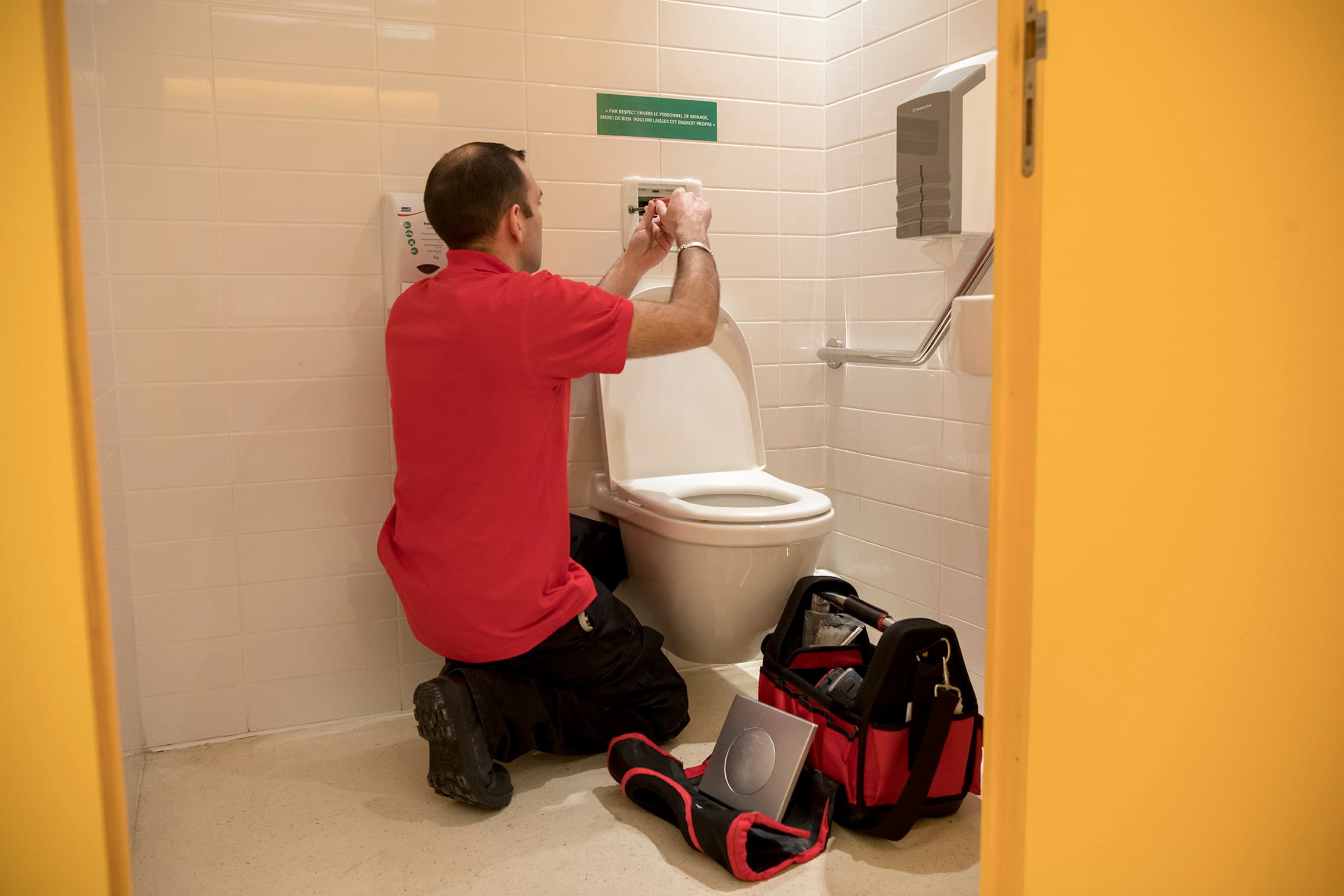 GSF technician working on a washroom fixture.