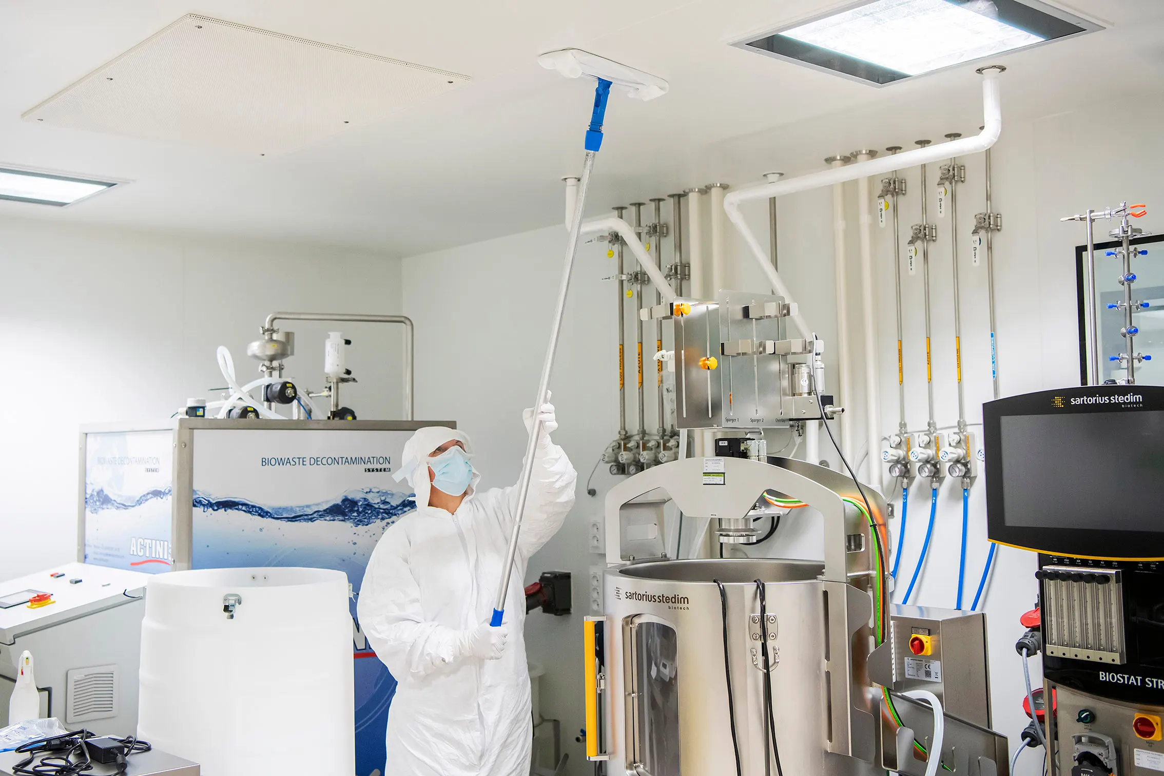 Pharmaceutical environment — PPE and controlled methods in action.